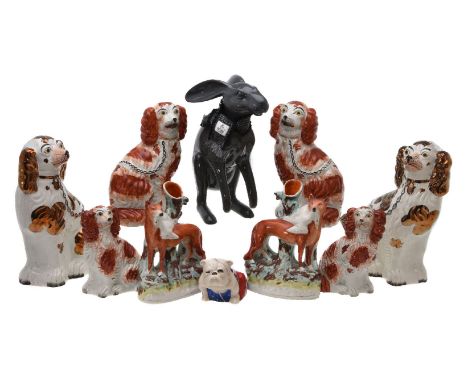 An assortment of mostly Staffordshire pottery animals, mid-19th century and later, comprising: a pair of fox and goose spill 