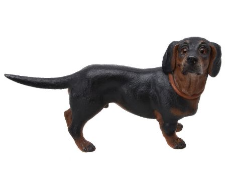 An Austrian painted terracotta model of a standing dachshund, first half 20th century, portrayed with head turned to dexter, 