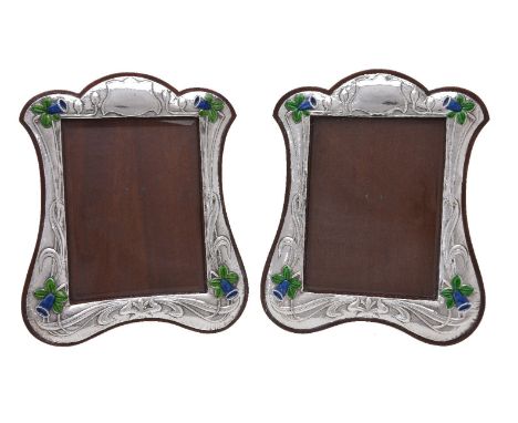 A pair of photograph frames by Keyford Frames Ltd, London 1985, shaped rectangular, embossed in the Arts and Crafts style wit