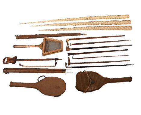 ϒ A collection of walking sticks, sports racquets and other items, 19th and 20th century, including a walnut and wrought iron