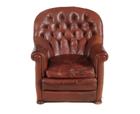 A leather button upholstered armchair, circa 1900, on squat bun feet