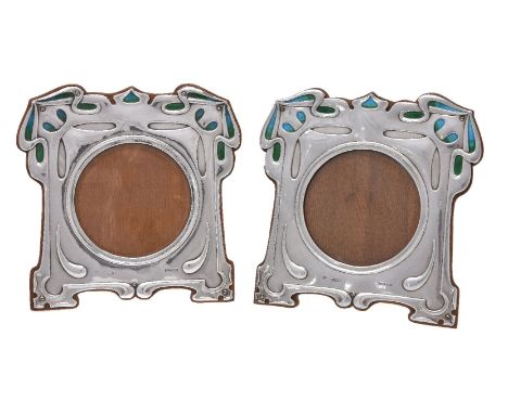 A pair of Arts and Crafts silver and enamel photograph frames by William Hutton &amp; Sons, London 1902, Rd. No. 404508, shap