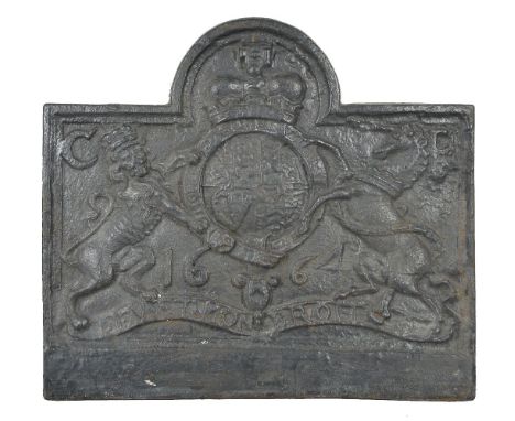 A Jacobean cast iron fireback, dated 1664, possibly made in the Weald, of arched rectangular form, cast with the Royal arms, 
