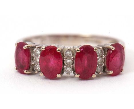 An 18ct ruby and diamond ring, the four oval faceted rubies with two small round diamonds between each stone, all claw mounte