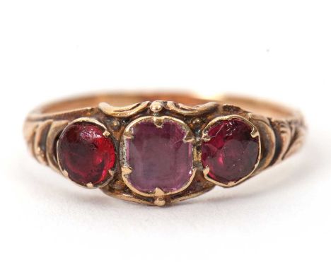 A 19th century pink sapphire and garnet ring, the central foil backed pink stone (possibly a sapphire) with a foil backed gar