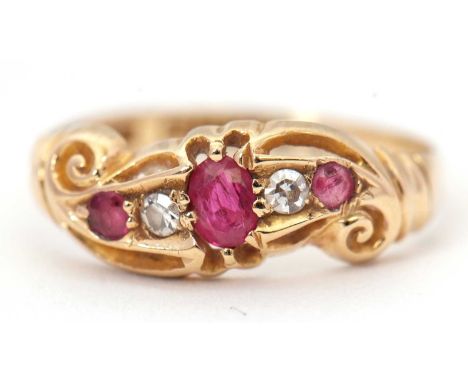 An early 20th century 18ct ruby and diamond ring, set with a central oval ruby, single cut diamonds and a further small round