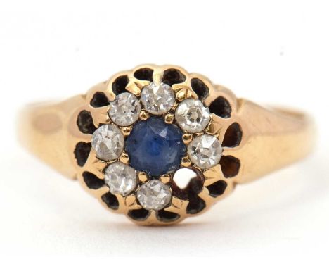A sapphire and diamond ring, the central round sapphire surrounded by single cut diamonds (one missing), with tapered shoulde