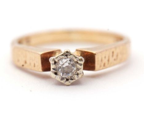A diamond solitaire ring, the illusion mounted brilliant cut diamond, estimated approx. 0.14cts, with textured shoulders and 
