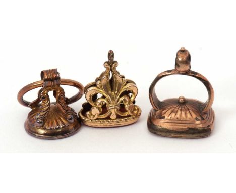 Three fobs: to include a marquise carnelian intaglio fob in unmarked yellow metal; a round carnelian intaglio fob in unmarked
