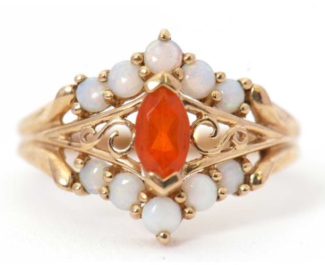A 9ct opal ring, set with a central marquise shape fire opal with small round opal cabochons above and below, interspaced wit