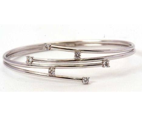 A 9ct and CZ bangle, the four strand bangle set with CZ, tapering to two bands stamped '375 CZ', inner diameter 6cm, 6.1g,