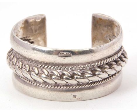 A silver bangle, the broad bangle, with a central rope twist band with finer rope twist edge and plain to either side, 32mm w