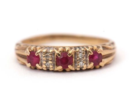 A 9ct ruby and diamond ring, the three round rubies interspaced with two diamond highlights to either side, with tapered shou