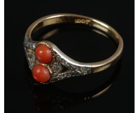 An 18ct gold coral and diamond ring. Size R. 3.38g.  