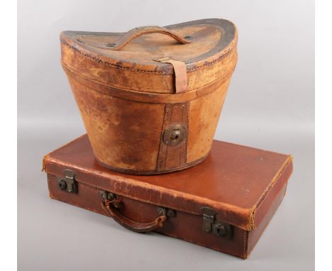 A Victorian top hat box along with a vintage suitcase.  