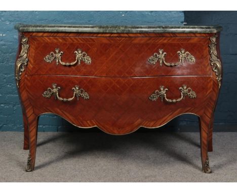 A bombe shaped commode with green marble top and quarter veneer. Comprising of two long drawers with brass decorative handles