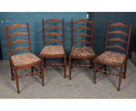 A set of four oak ladder back dining chairs.  