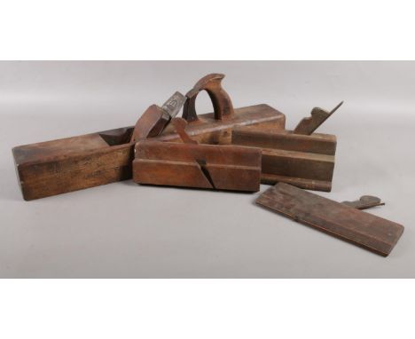 A large mahogany R. Fairclough fore plane, with I. Sorby blade, together with three rebate planes. R. Fairclough plane: 57cm 