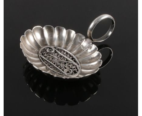 A silver caddy spoon with filigree decoration to bowl. (Tests as silver). 7.23g.  