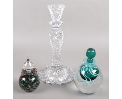 A Waterford Crystal candlestick along with two art glass scent bottles, one by Adrian Sankey.  