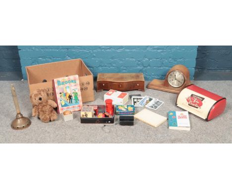 A box of miscellaneous. To include mantle clock, breadbin, games toys and postcards etc.  