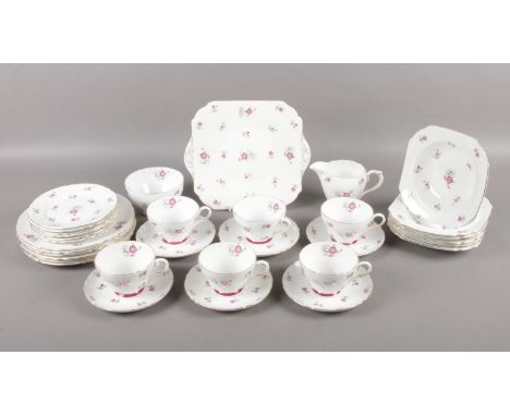 A Shelley teaset in the 'Charm' pattern. Comprising of six cups and saucers, six plates, six side plates, six bowls, milk, su