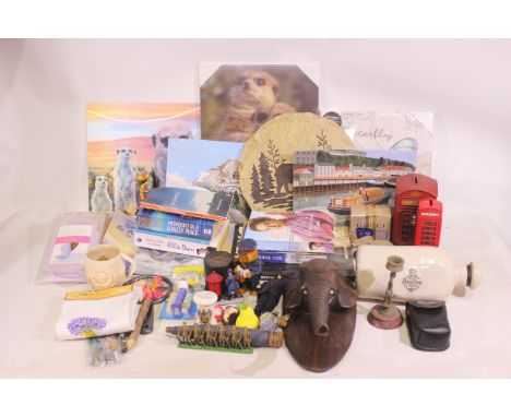 Mixed lot to include books, two metal telephone booth money boxes, wooden carved wall hanging elephant head, and similar. Lot