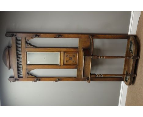 Early 20th century oak hall stand, central bevelled mirror above carved panel, hinged compartment, turned supports with stick