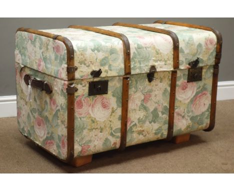 Wooden bound trunk with leather carrying handles, upholstered in floral pattern fabric, W82cm