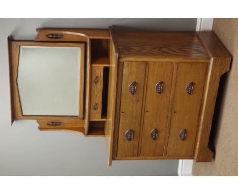 Arts & Crafts oak dressing chest with raised swing mirror, trinket drawer above three long drawers, on plinth base with casto