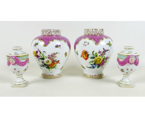 A pair of Meissen Neo-Classical small vases, likely 19th century, the urn shaped form modelled with mask escutcheons and swag