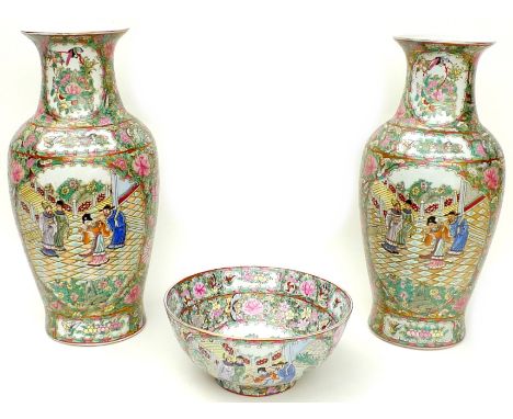 A pair of 20th century Chinese Canton porcelain baluster vases, typically decorated with reserves of courtier scenes in archi