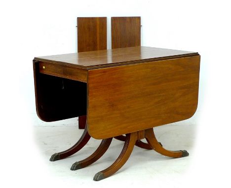 A Regency style mahogany sofa / dining table, circa 1970, of unusual form with drop leaves and extending action, with two add