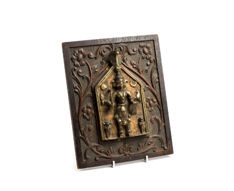 A CAST BRASS VIRABHADRA PLAQUE, WESTERN DECCAN, INDIA, 19TH CENTURY the four-armed god depicted in relief holding various wea