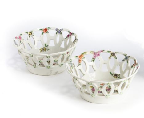A PAIR OF WORCESTER BASKETS, CIRCA 1765 the deep, round baskets with circular chain link piercing moulded with green dot pain