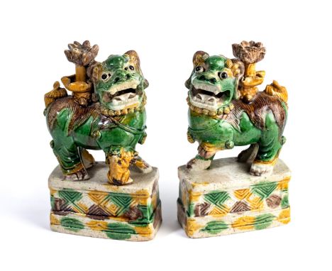 A PAIR OF CHINESE SANCAI GLAZED BUDDHIST LION JOSS STICK HOLDERS, KANGXI PERIOD (1662-1722) the opposing figures each applied