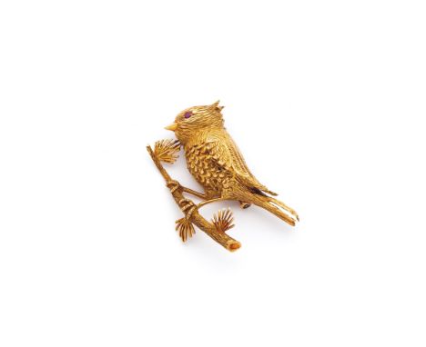 GOLD BROOCH, BOUCHERON, PARIS, LATE 20TH CENTURY designed as a chased bird perching on a branch, the eye set with a circular 