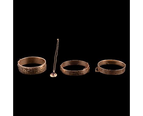 A red paste pendant on a chain, and three yellow metal half hinged bangles with metal cores, a red paste pendant on a yellow 