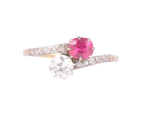 A ruby and diamond crossover ring, a 5.85mm old brilliant cut diamond and a 6x5.4mm oval mixed cut ruby, claw set in a yellow