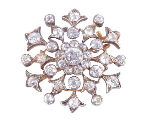 A diamond brooch in Garrard box, the central old brilliant cut stone surrounded by nine old cut stones with twelve old cut st