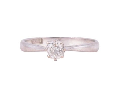 A diamond solitaire ring, the old cut stone claw set in a white metal mount ring size K½, shank marked 18ct, 2g.