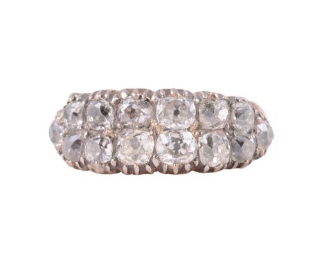 A diamond two row half hoop ring, fourteen old cut diamonds claw set in an all yellow metal mount with closed back setting ri