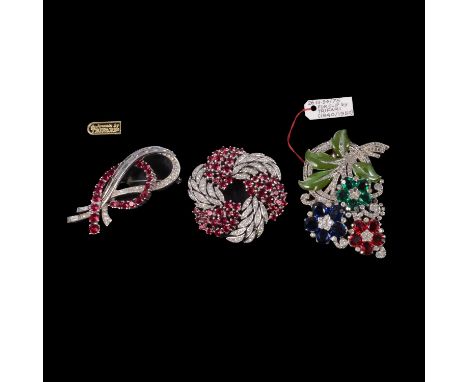 Two signed Crown Trifari brooches and a fur clip, a circular 50mm diameter rhodium-plated brooch set with swirls of faux rubi