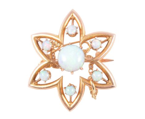 An opal brooch, the central circular cabochon cut stone surrounded by six smaller cabochon cut stones, all claw set in a yell