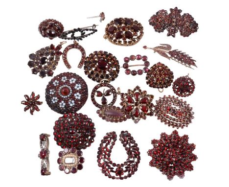 Twenty-four Georgian and later garnet brooches, pendants and stick pins, a small Georgian closed back memorial brooch with se