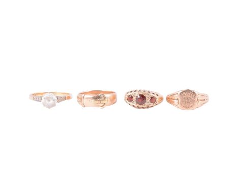 Four vintage gold rings, a 9 carat yellow gold signet ring size P; buckle ring size L; garnet three stone ring size K; and a 