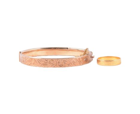 A 9 carat yellow gold half hinged bangle, and a 22 carat gold ring, a 7.9mm wide 9 carat yellow gold hollow half hinged bangl