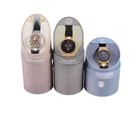 Three Citizen Eco-Drive wristwatches, one with a plain black dial with date aperture in a gold-plated case with integral brac