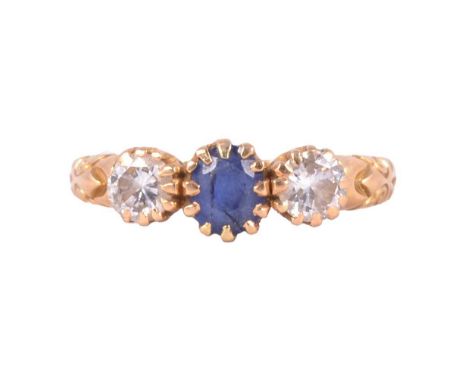 A sapphire and diamond ring, the brilliant cut sapphire and two brilliant cut diamonds claw set in an unmarked yellow metal m