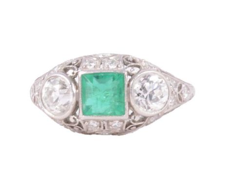 An emerald and diamond three stone ring with smaller diamonds, the square cut emerald, approximately 5.5mm, with a brilliant 